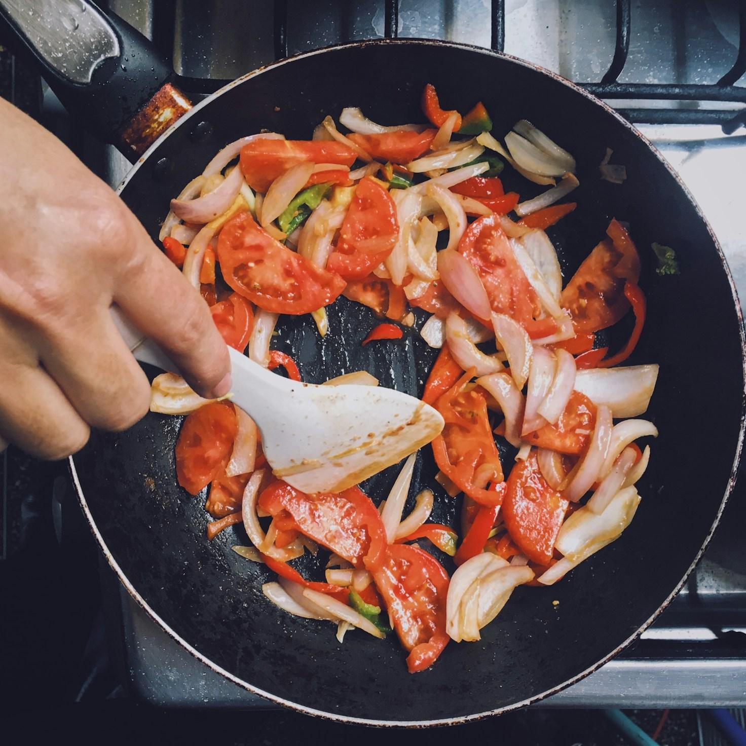 Community members collaborating in a modern kitchen, sharing recipes and techniques